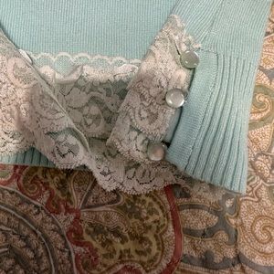 Soft blue sleeveless top with lots of detail.